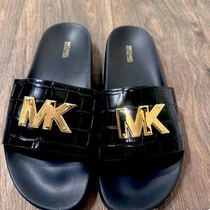 Never worn black and gold Michael Kors slides size 10.
